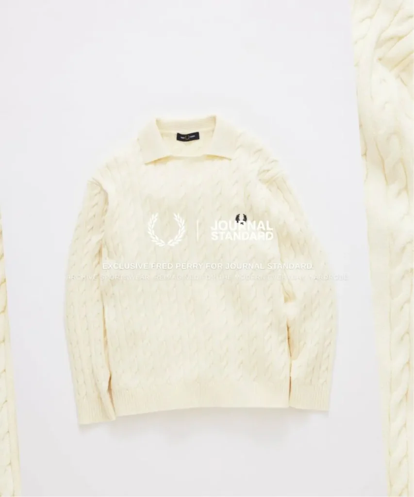 Cream Fred Perry cable-knit collared sweater with dark Laurel Wreath embroidery, presented with JOURNAL STANDARD collide brand