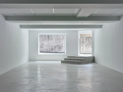 Min Concrete Gallery Interior With Polished Gray Floor And Linear Ceiling Light