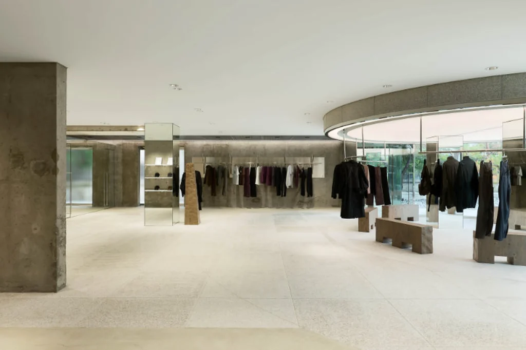 Min Fashion Store Interior With Concrete Walls And Circular Glass Display