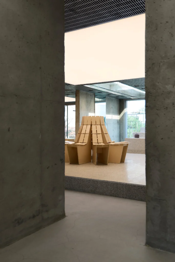 Sculptural Wooden Chair Display Framed By Raw Concrete Wall