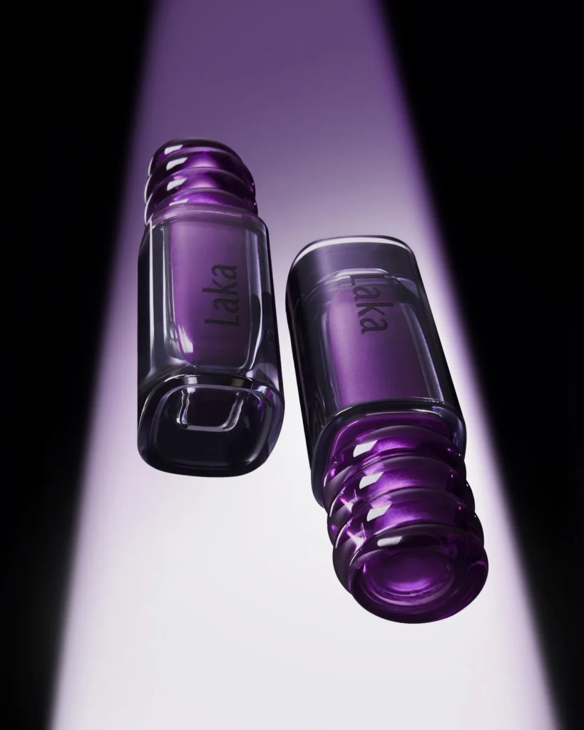 Two Laka purple lip product display under a drama lavender spotlight, showing translucent rectangular packaging and sculpture purple cap