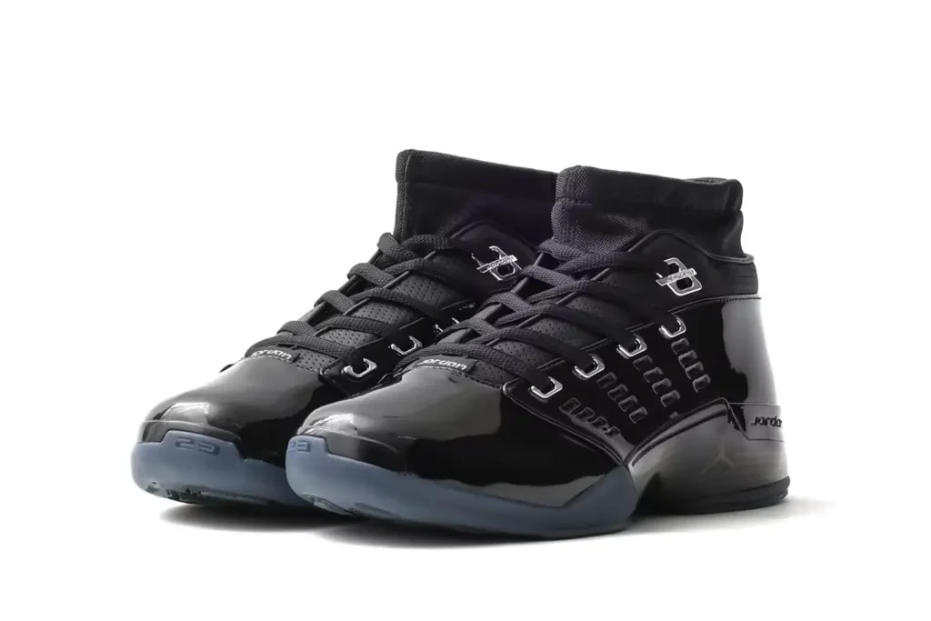 Pair of glossy black Jordan high-tops photographed from a front three-quarter angle on white