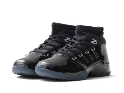 Pair of glossy black Jordan high-tops photographed from a front three-quarter angle on white
