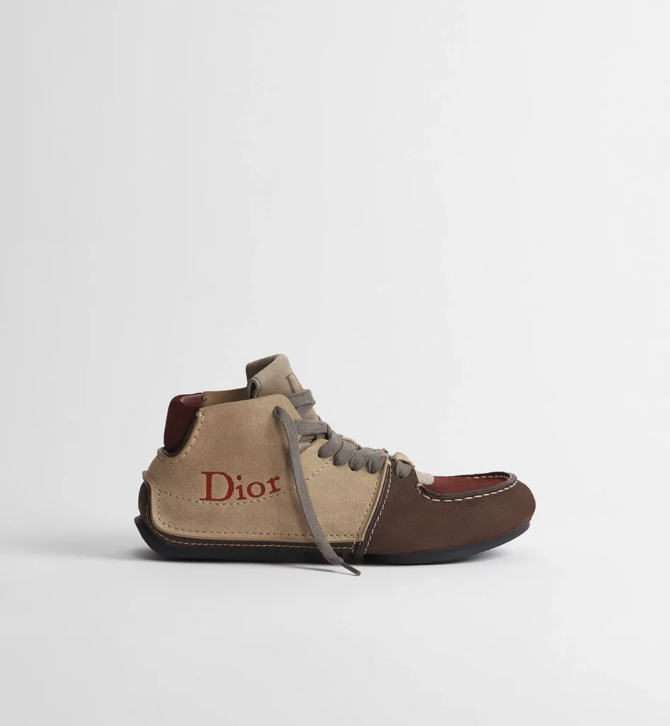 Dior high-top shoe in beige and brown suede with burgundy accents, gray laces, contrast stitching, and red Dior brandi