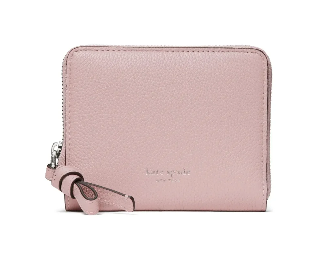 Pebbled blush pink leather zip-around wallet featuring silver-tone logo lettering and a knotted leather zipper pull