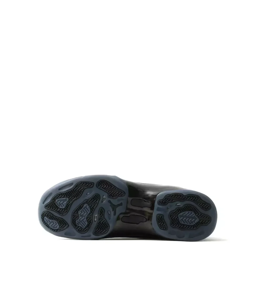 Bottom view of the Jordan shoe showing the black and dark blue patterned rubber outsole