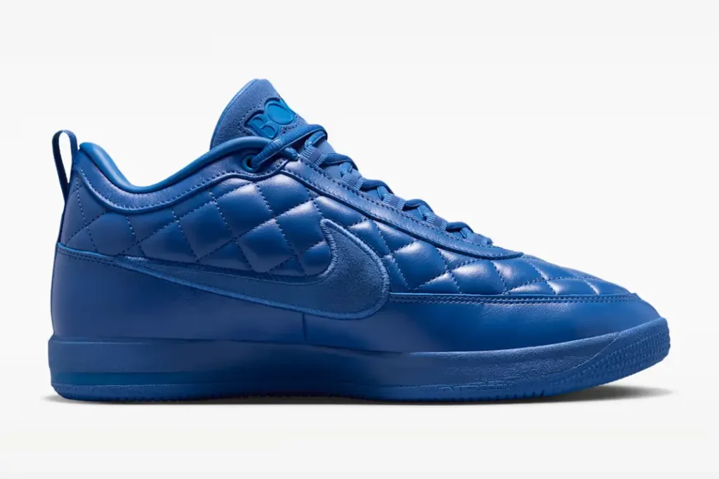 Side profile of the monochromatic blue Nike shoe feature a quilt leather upper, tonal Swoosh and match blue sole