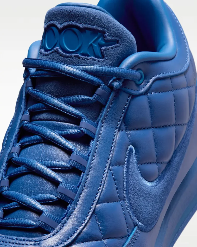 Close-up of the blue Nike shoe lace sys, suede tongue, quilt leather upper and tonal Swoosh
