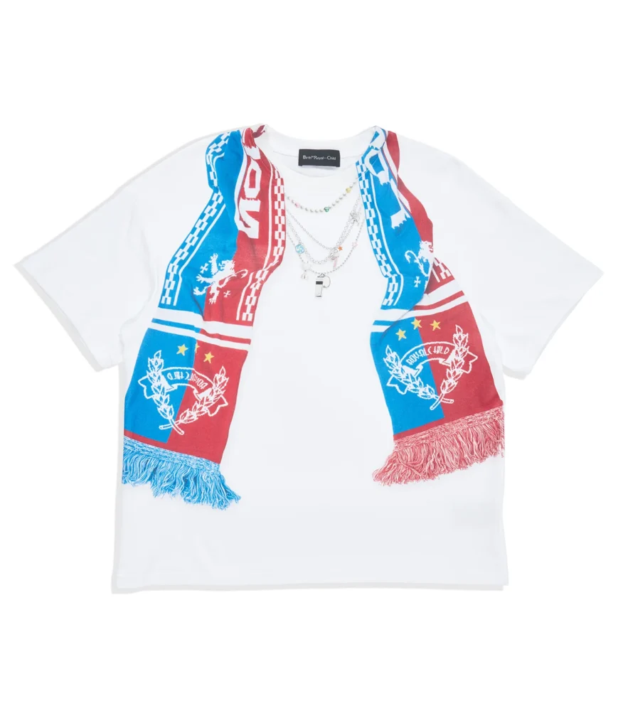 White oversized Tee featuring an integrated red-and-blue soccer scarf graphic draped around the neckline with fringe-print details, crest graphics, layered silver necklaces, and Birth®RoyalChild brand
