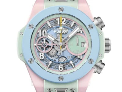 Hublot Big Bang watch feature a pastel blue bezel, mint green and pink case, skeletonize dial, yellow second hand, and ribb blue strap on a white background