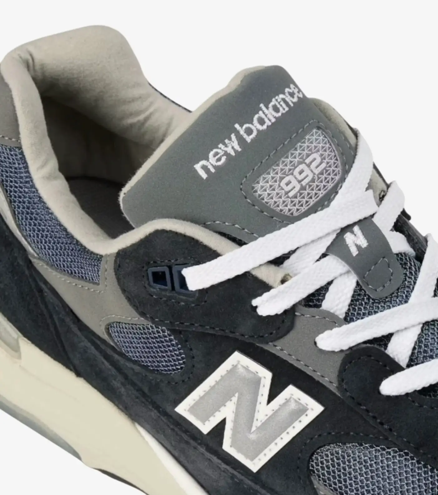 Close-up of gray and black New Balance 992 sneaker with white laces and large N logo