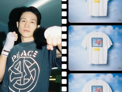 Person wearing a black PEACE graphic Tee with white hand wraps poses in a boxing stance beside a filmstrip-style display featuring multiple Disney Dumbo graphic Tee against a sky background