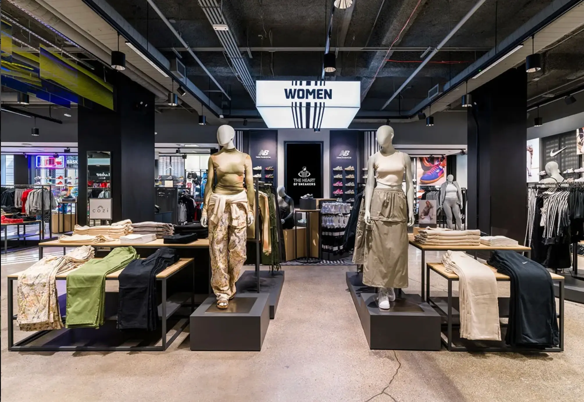 Foot Locker women’s section with mannequins, apparel displays and footwear walls.