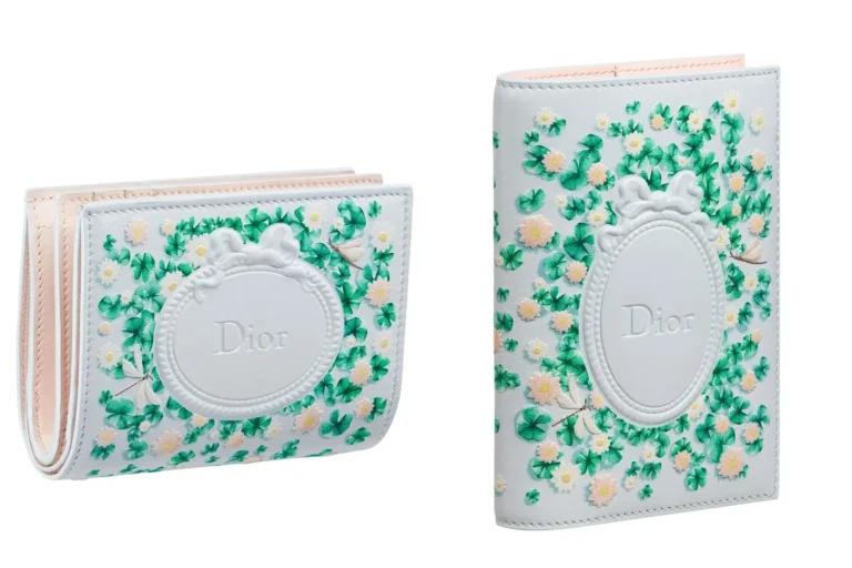 White leather accessories with an embossed oval Dior plaque, decorated in hand-painted green clovers, tiny pastel flowers, and delicate butterflies