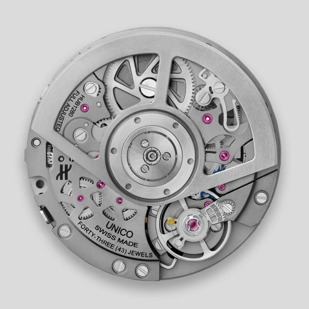 Hublot UNICO automatic movement display a silver rotor, expose gear, screw, balance assembly, and magenta jewel bearing in a detail