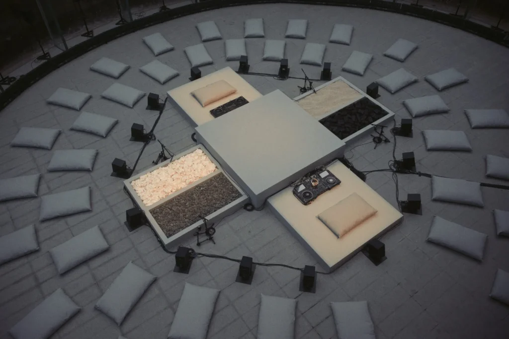 Overhead View Of Circular Performance Space With Cushion, DJ Equipment, Speaker And Textural Install