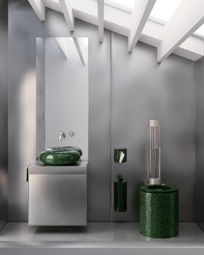 Minimal gray bathroom with a floating vanity, green terrazzo basin and toilet, polished concrete walls, and a skylight flooding the space with natural light