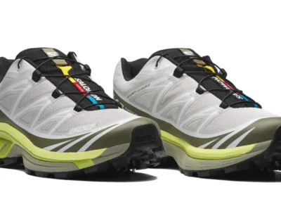 Angled view of the Salomon XT-6 trail running shoes featuring a white mesh upper, olive mudguard, Quicklace system, and neon yellow midsole