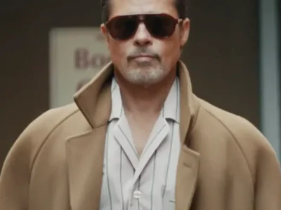 Brad Pitt in camel and stripes. A stringent calm behind dark aviators. No fuss. Just indelible presence, walk the city like he own the pavement