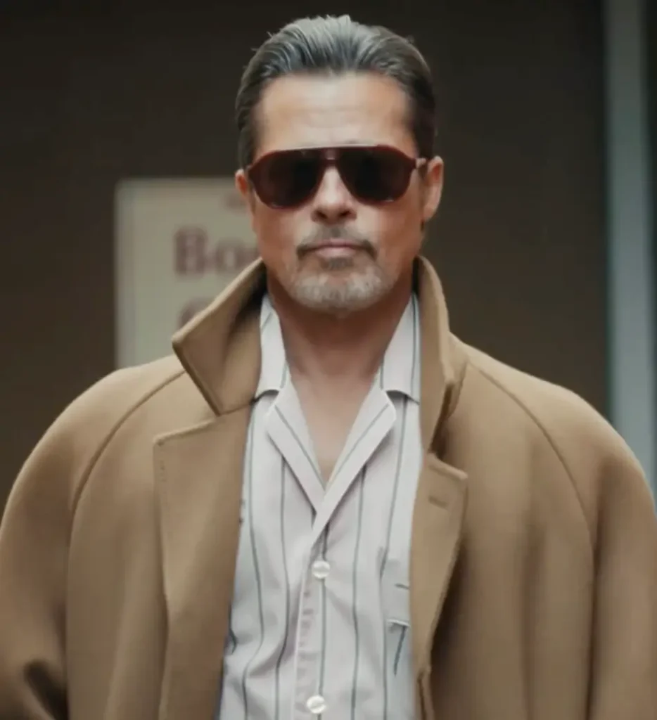 Brad Pitt in camel and stripes. A stringent calm behind dark aviators. No fuss. Just indelible presence, walk the city like he own the pavement