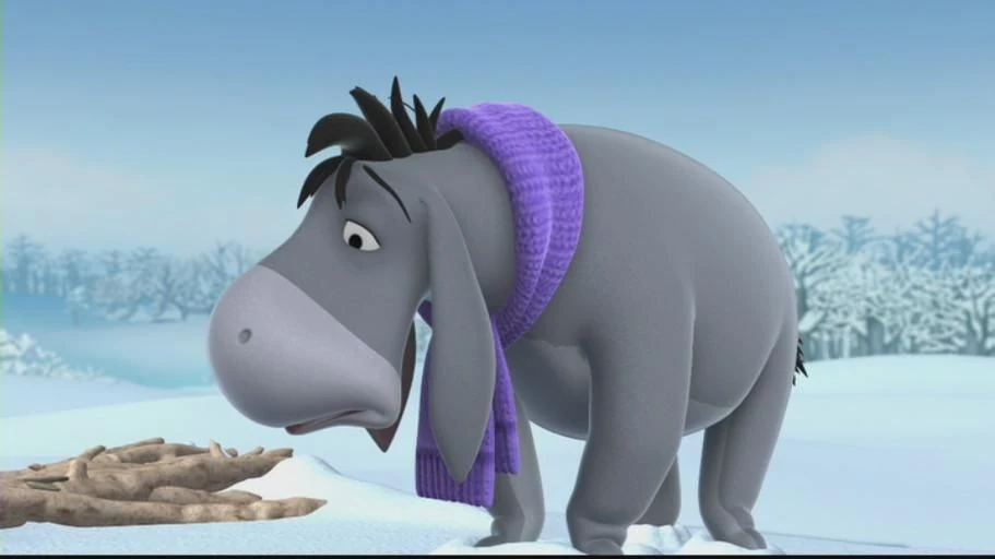 Animated Eeyore wearing a purple scarf stands in a snowy landscape beside a fallen branch