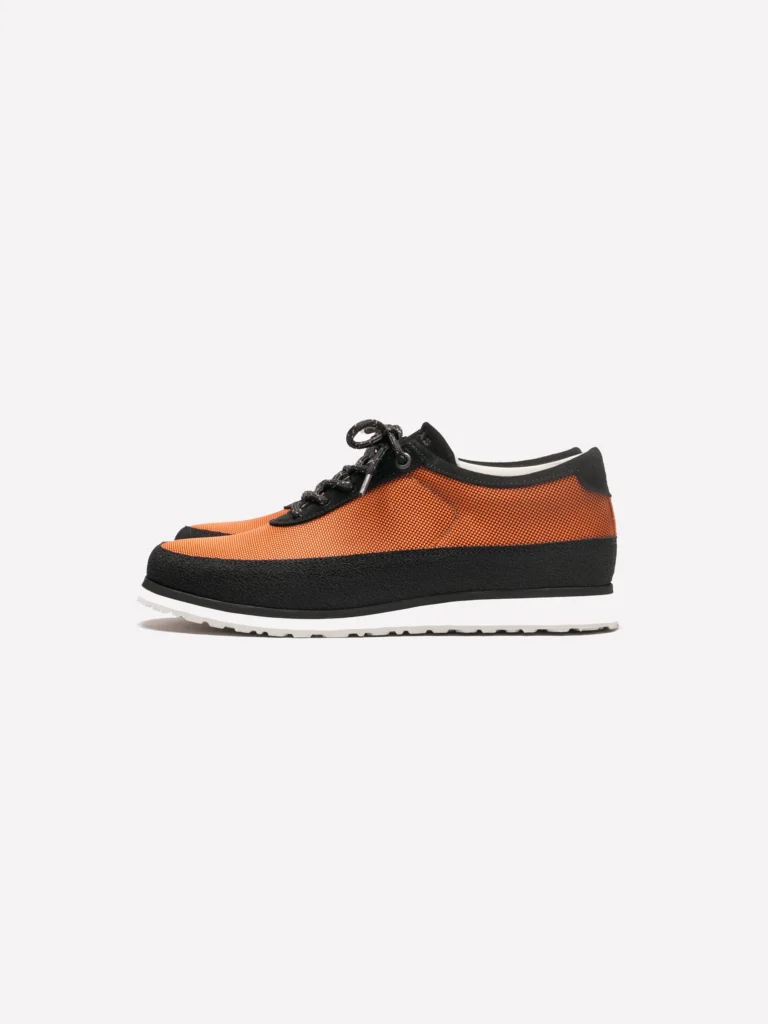 Bright metallic orange mesh sneaker with black suede overlays, black laces, and a white lightweight rubber sole