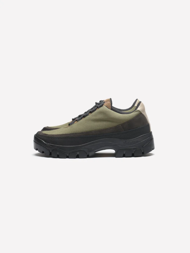 Olive green Cordura hiking shoe with black suede overlays, black laces, beige heel accent, and a rugged black Vibram outsole