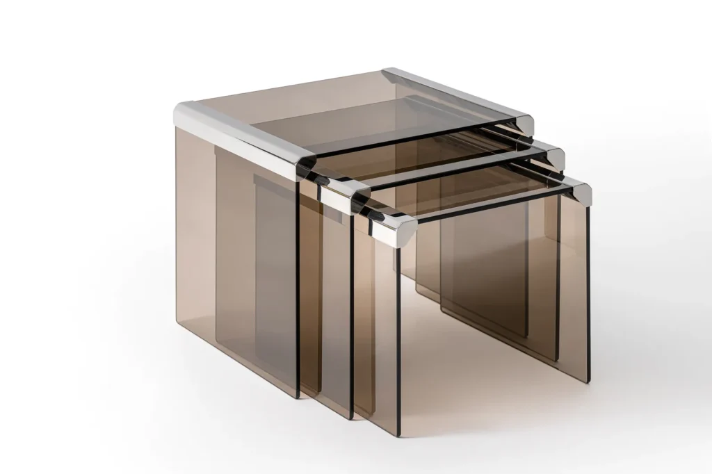 Set of three nest table made from translucent smoky brown material with polish metallic edge detail