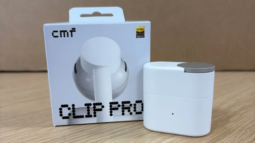 CMF Clip Pro Retail Package Beside The White Charge Case With Silver Smart Dial