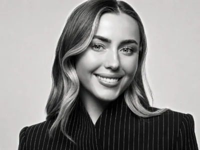 Monochrome Studio Portrait Of A Smiling Aimee Smale In A Pinstripe Blazer With Subtle Film Grain