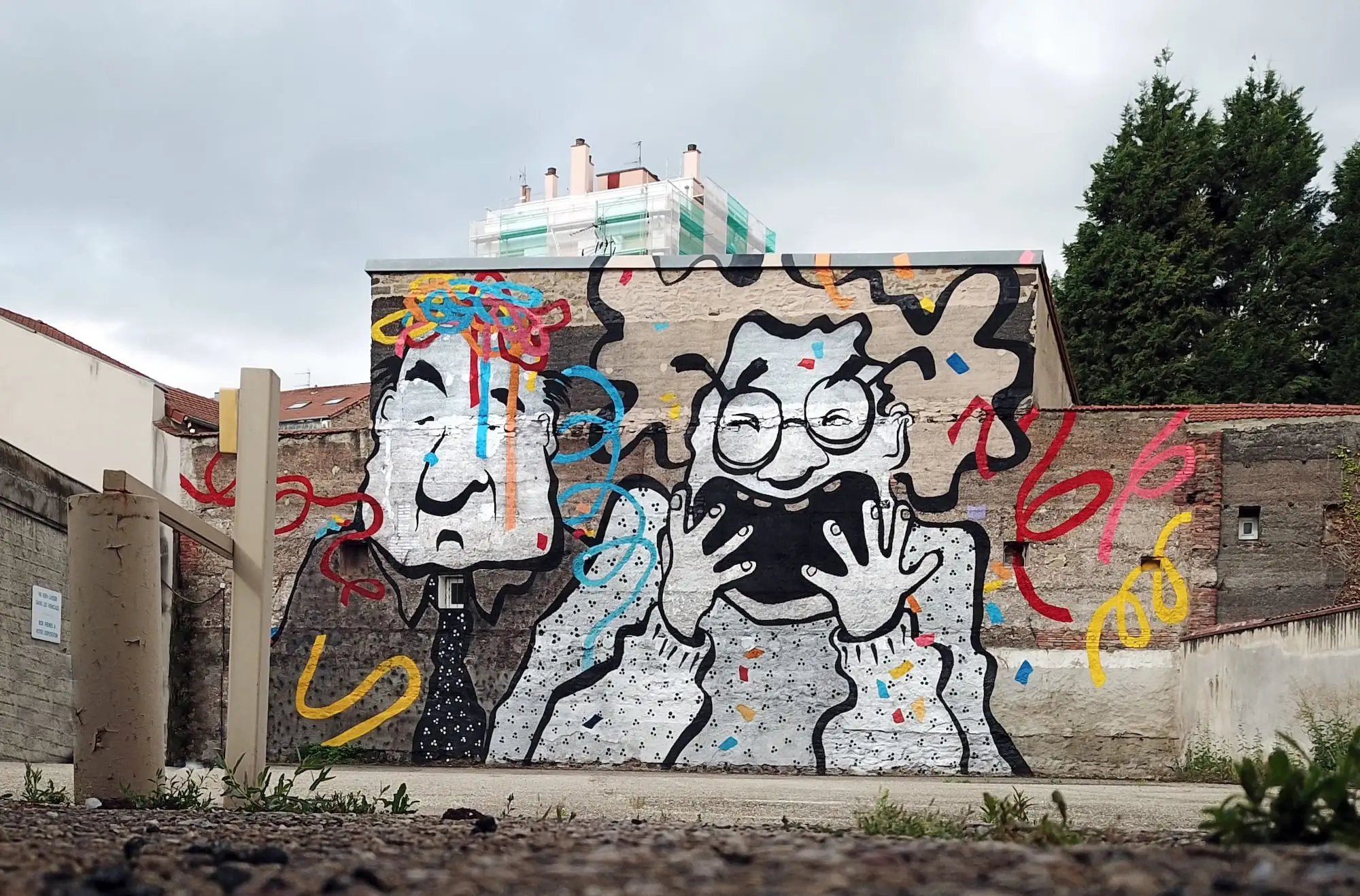 Ella & Pitr mural depicting two expressive figures surrounded by colorful looping lines and confetti-like details.