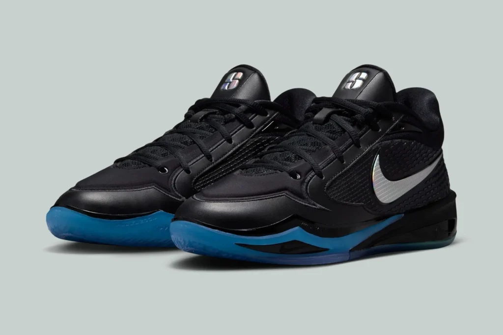 Angled pair of black Nike basketball shoes with metallic Swooshes and bright blue translucent sole