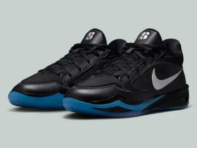 Angled pair of black Nike basketball shoes with metallic Swooshes and bright blue translucent sole