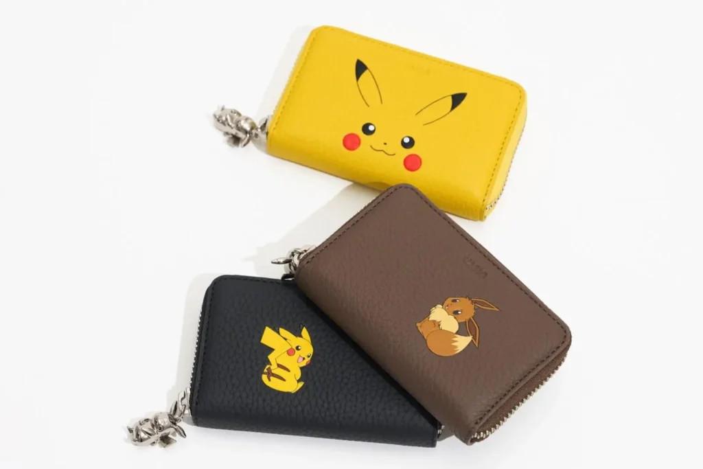 hree compact zip-around leather wallets featuring Pikachu and Eevee artwork in yellow, black, and brown colorways with character zipper charm