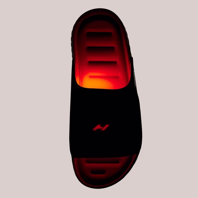 Top-down view of the black Nike Air Zoom Hyperslide featuring a wide strap with a glowing Hyperice symbol and an illuminated red-orange recovery footbed.