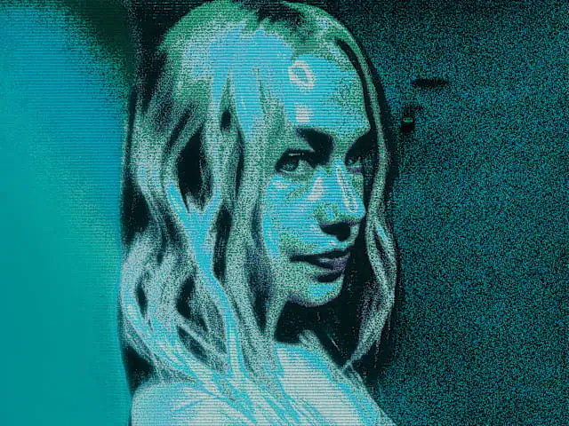 Phoebe Bridgers Poses In A Grainy Teal-Tinted Portrait.