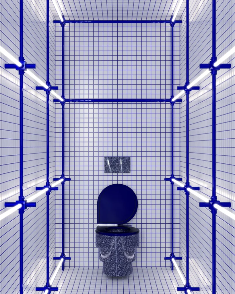 Graphic tiled restroom with blue grid walls, exposed blue pipe framing, linear LED lighting, and a terrazzo-style toilet creating an industrial-inspired aesthetic
