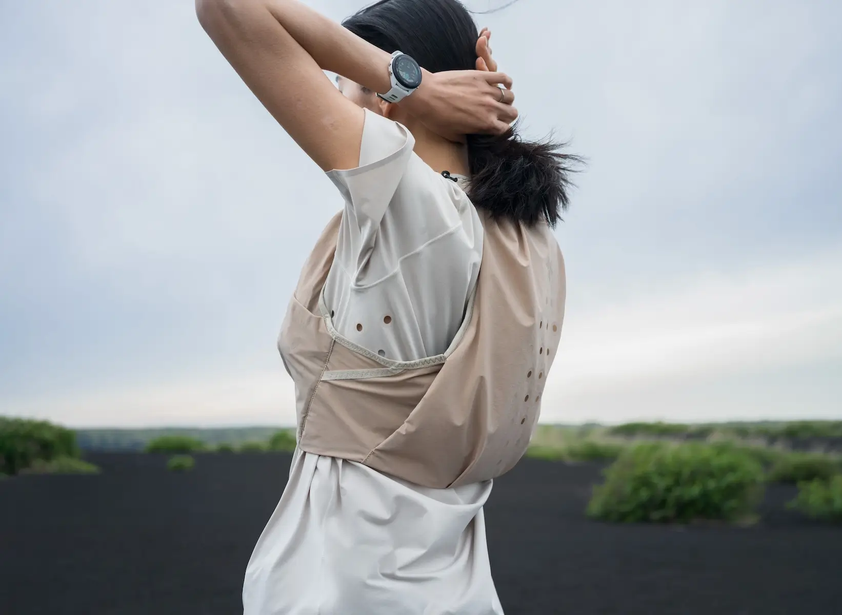 Woman Wearing A Lightweight Beige Running Vest And White Sports Watch Outdoors