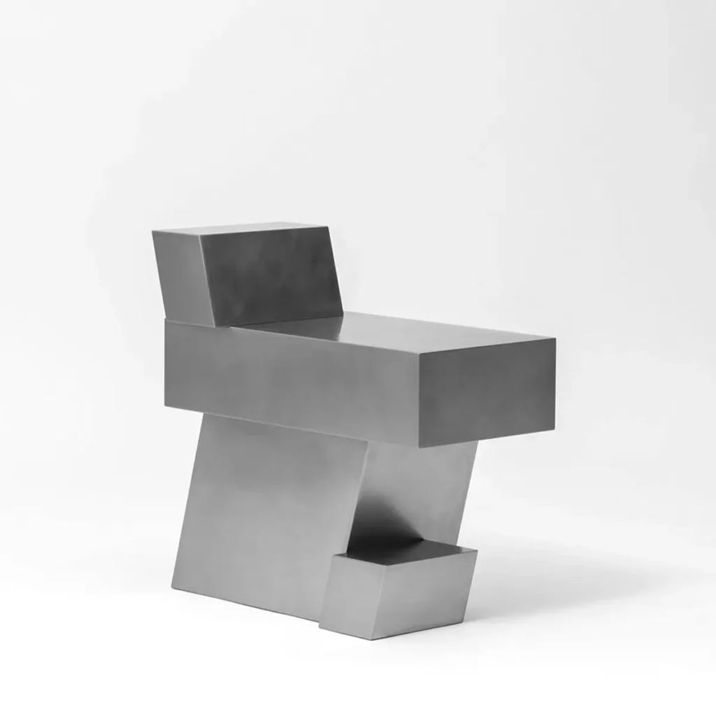 Angular stainless steel chair by Hyunsin Ghwang compose of interlock rectangular volumes, shown from a three-quarter angle highlight the stagger backrest and step base