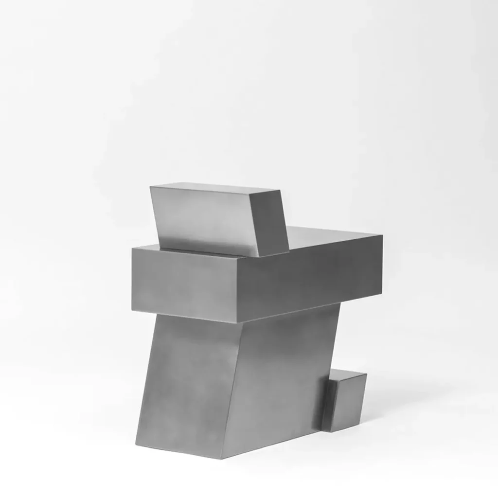 Rear three-quarter view of a stainless steel geometric chair by Hyunsin Ghwang, show the angle support structure and small cantilever foot block