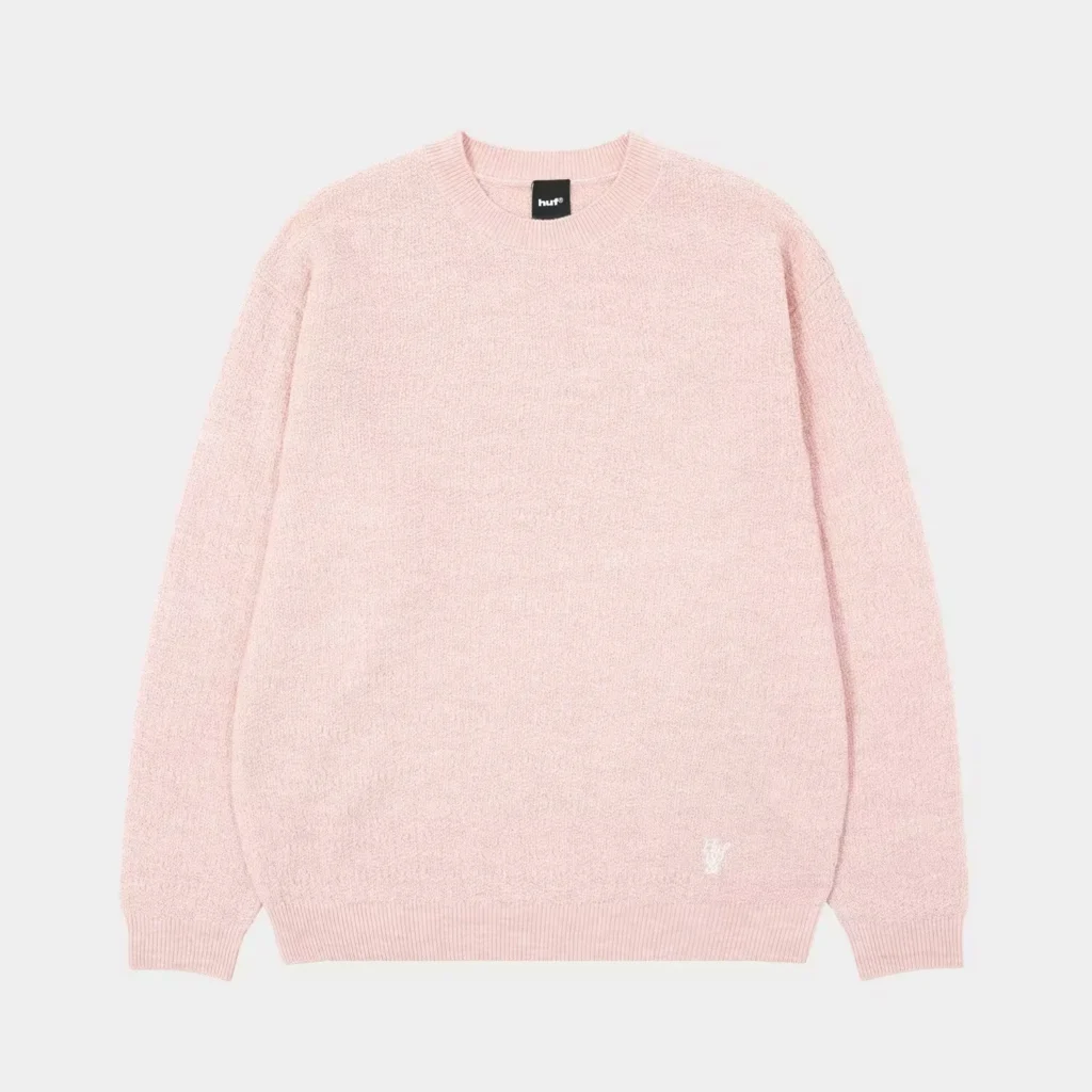 Pale pink HUF crewneck sweater with ribbed collar, cuffs and hem, photographed flat against a light background