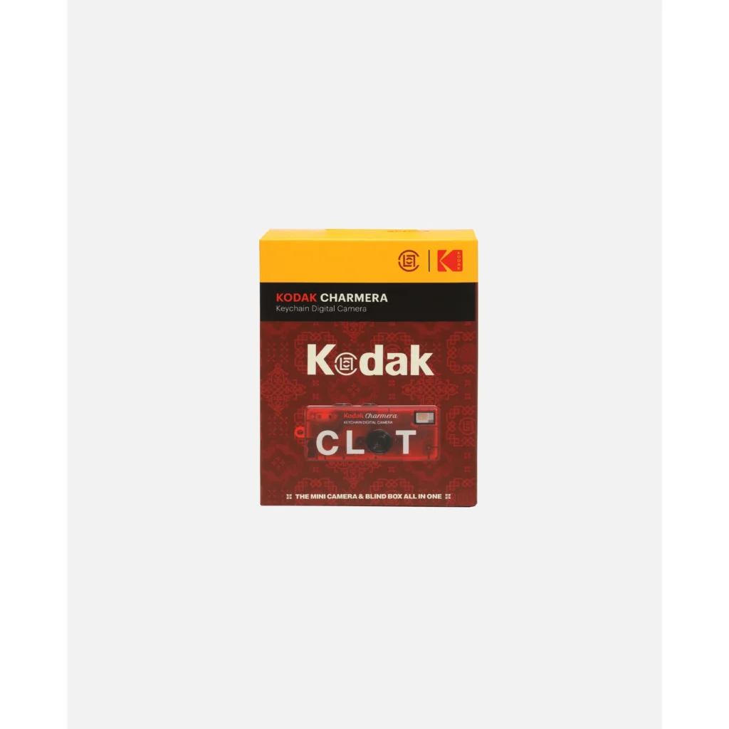 Yellow, black, and red Kodak Charmera keychain digital camera blind box with CLOT branding on a white background