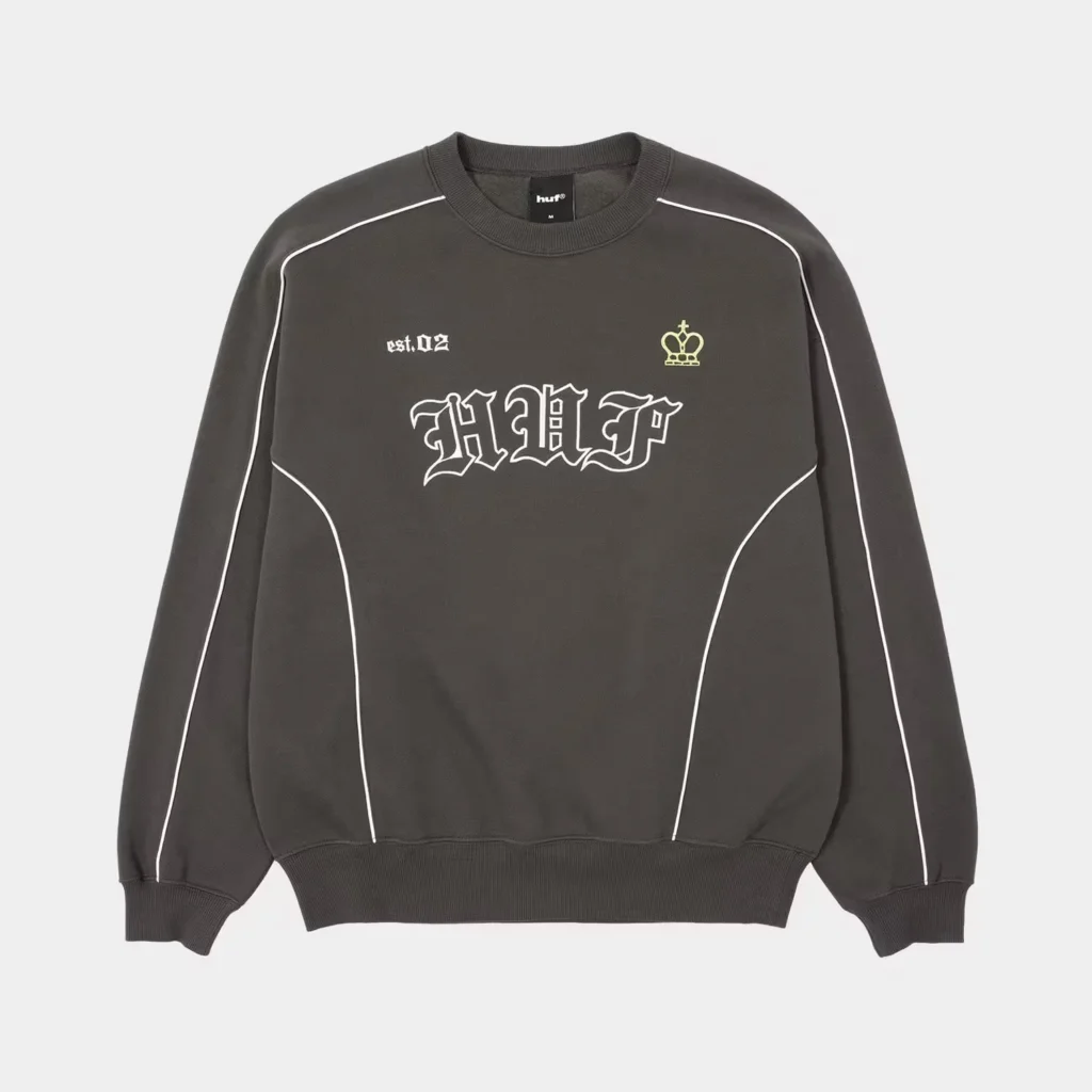 Black HUF crewneck sweatshirt with white piping, gothic HUF logo, small crown emblem, and ribbed cuffs on a light background