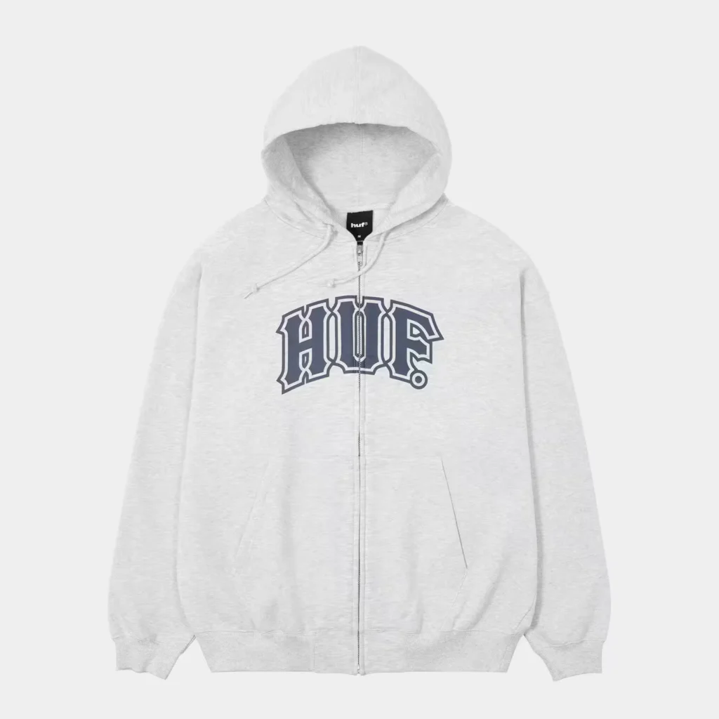 Light gray zip-up hoodie with a hood, kangaroo pockets, and large dark HUF lettering, shown against a white background