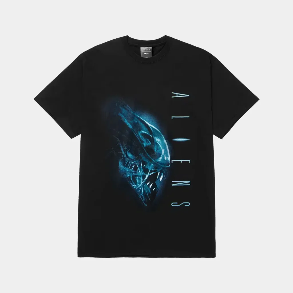 Black T-shirt featuring a blue Xenomorph graphic and vertical pale-blue lettering, displayed flat against a light background
