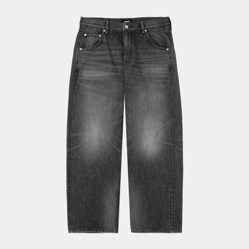 Black HUF jeans with a button fly, five pockets and wide straight legs against a light gray background