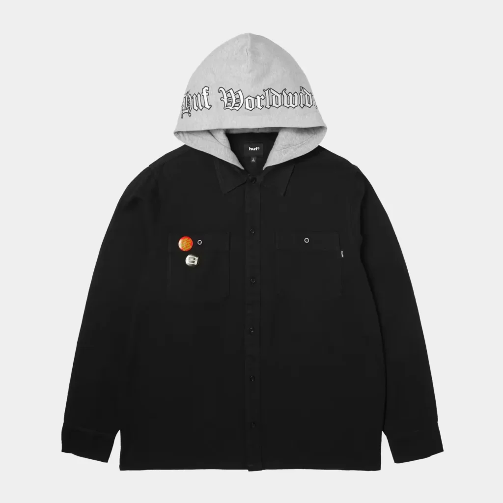 Black button-up overshirt with two chest pockets, gray hood, and “Huf Worldwide” lettering, shown against a white background