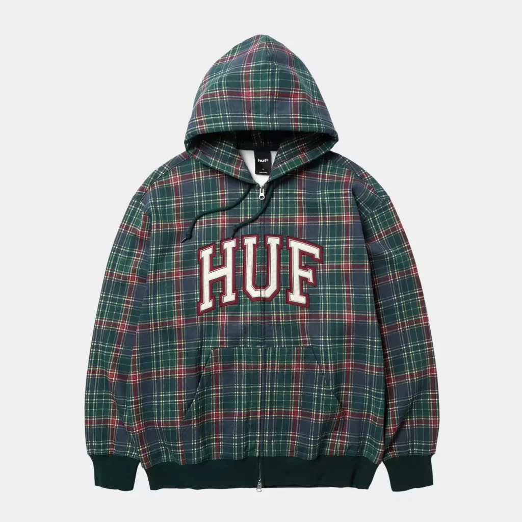 Green and burgundy plaid HUF pullover hoodie with a zip front, drawstrings, and large varsity-style chest logo on a white