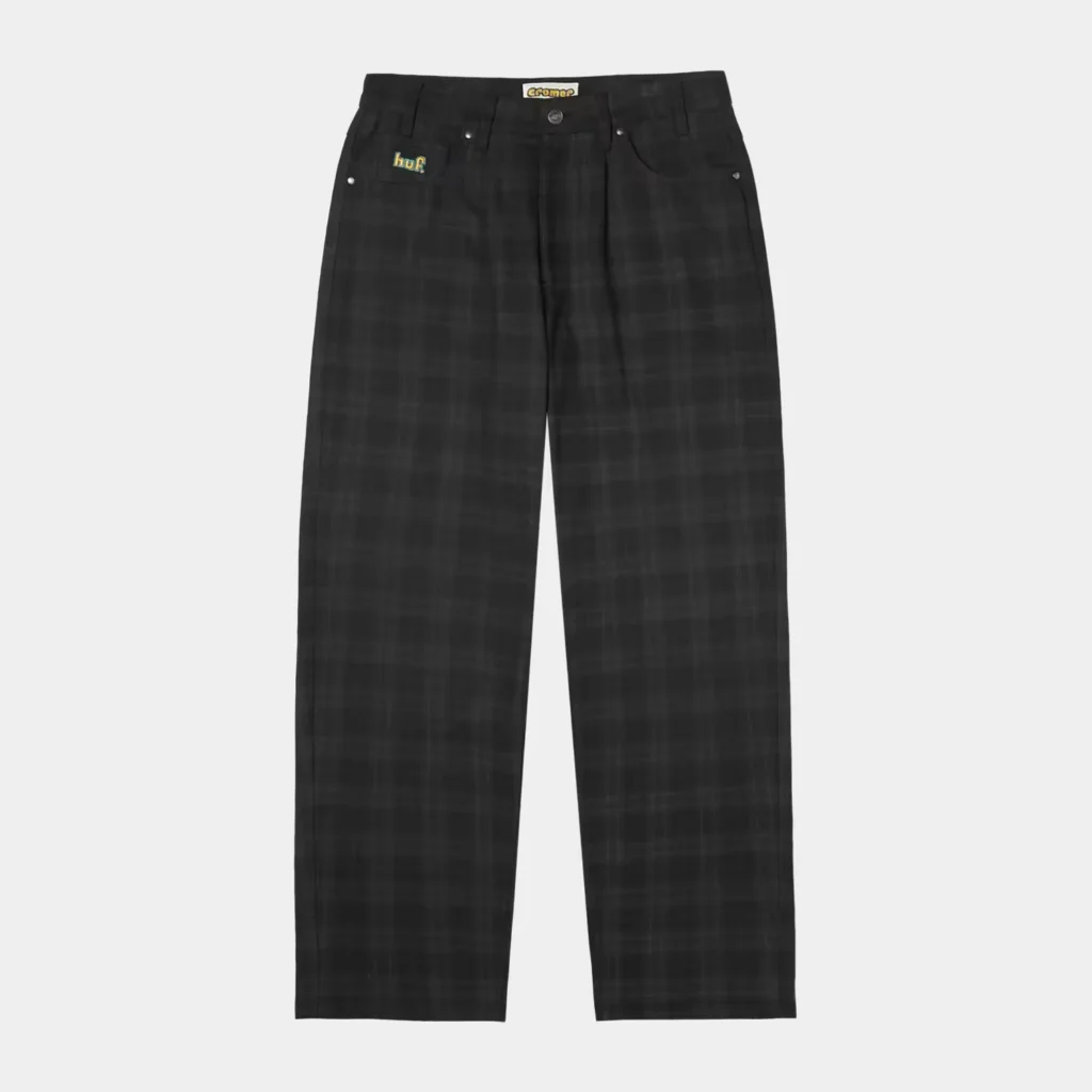 Black plaid pants with a HUF logo patch and a Weyland-Yutani label, shown against a light gray background
