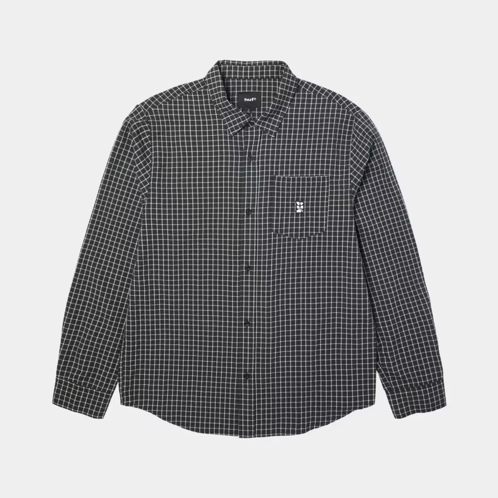 Black HUF button-up shirt with a white windowpane grid, long sleeves, and chest pocket on a light background